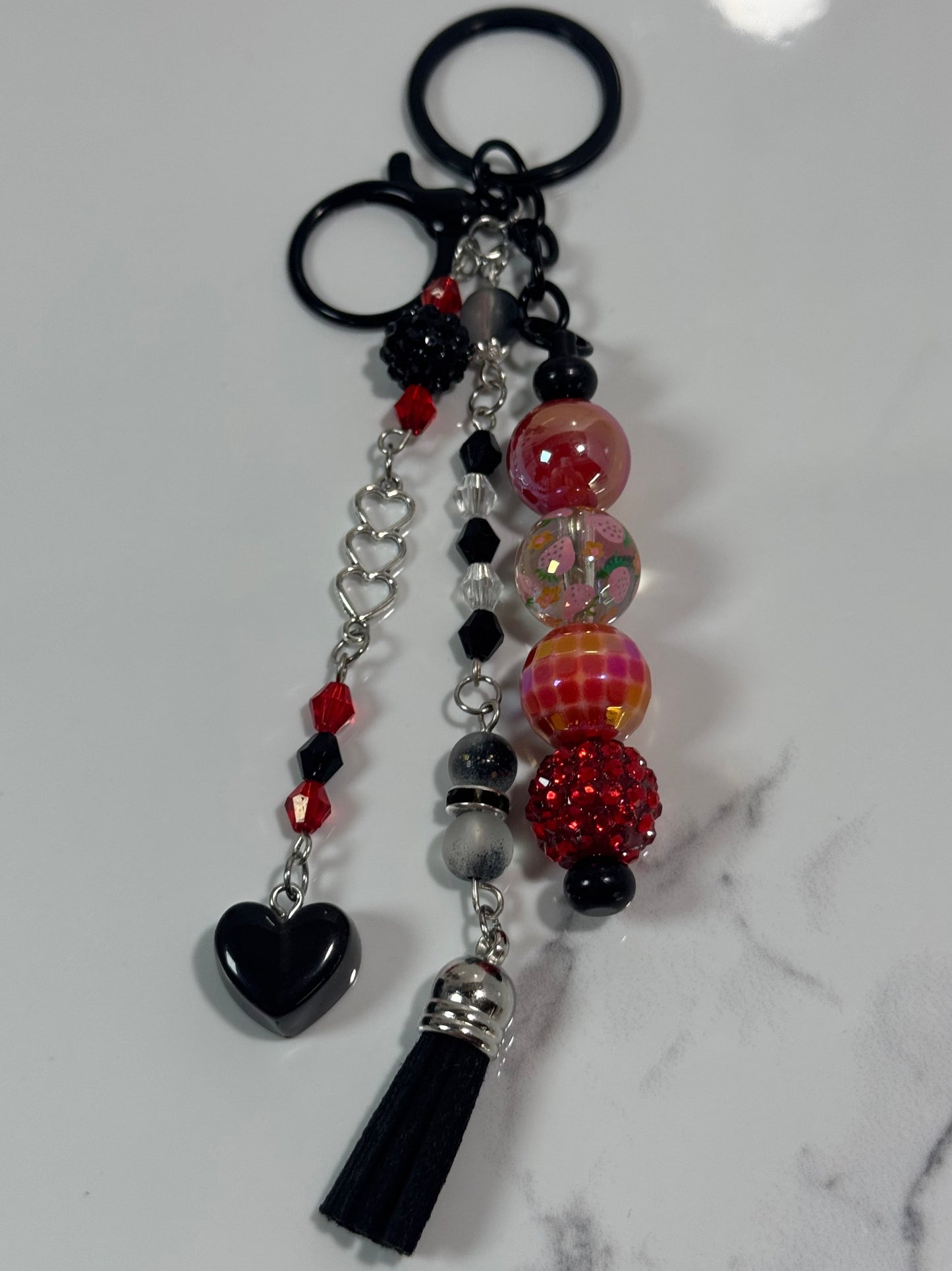 Decorative keychain with beads and tassel on a marble surface