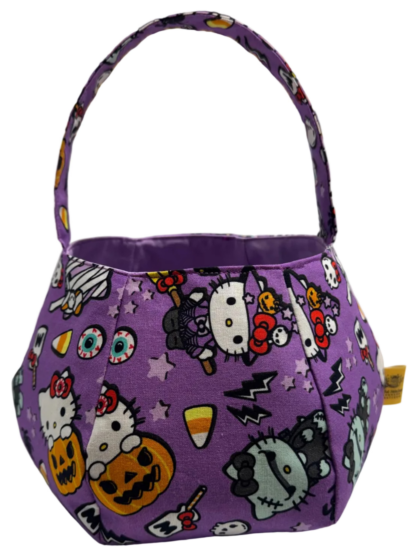 A purple fabric Halloween basket bag with a spooky character print on  a purple background and lilac interior.