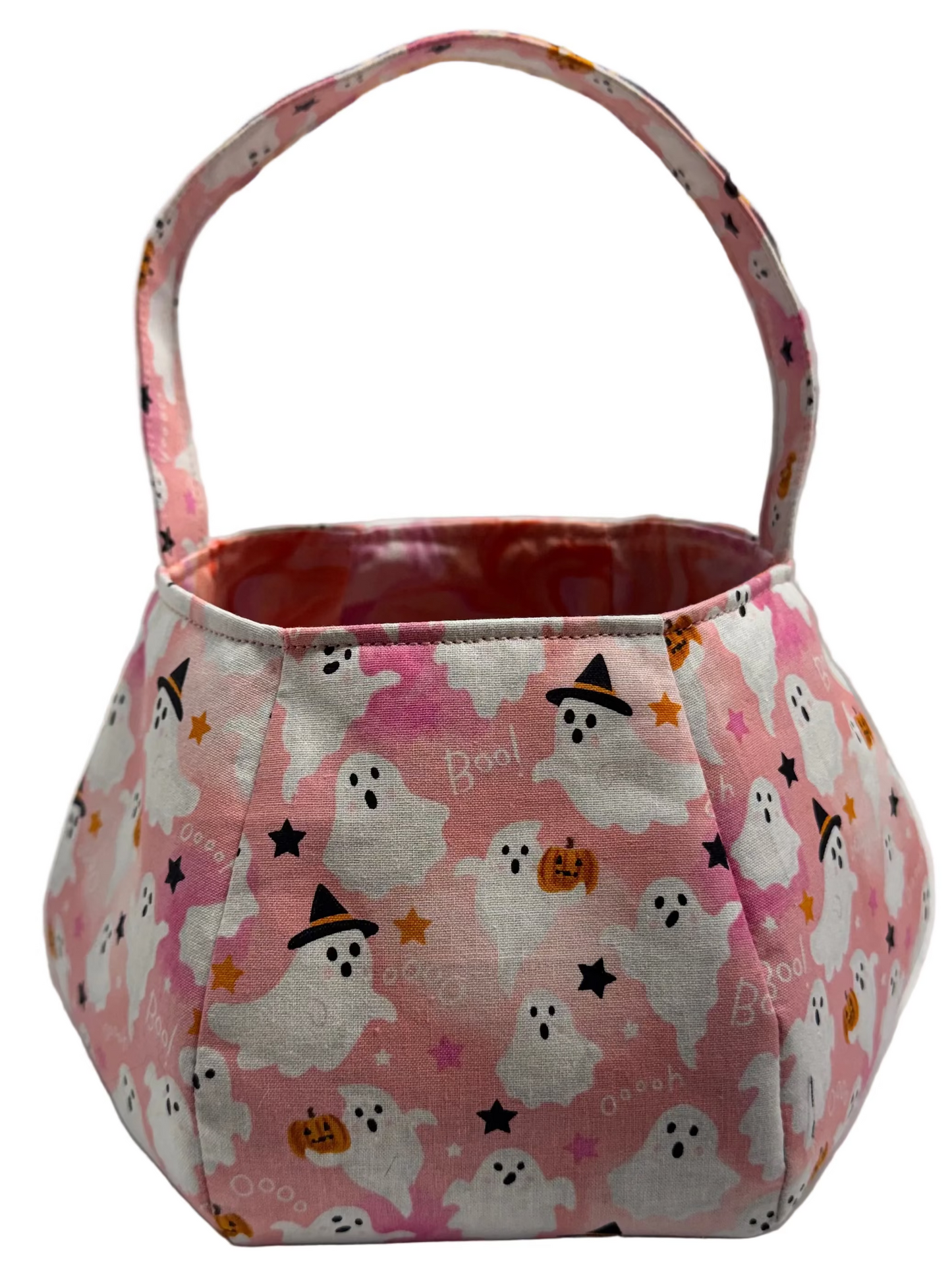 A small fabric basket bag with a pink and white ghost pattern, featuring a top handle and a pink and orange marble interior.